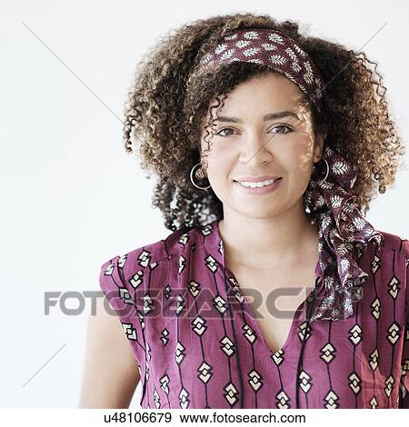 Stock Photo - Portrait of smiling woman with curly hair. Fotosearch