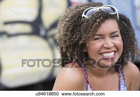 Portrait of smiling young woman with curly hair View Large Photo Image Stock Image - Portrait of smiling young woman with curly hair. Fotosearch