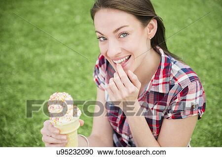 Portrait of woman eating ice cream cone View Large Photo Image Stock Image - Portrait of woman eating ice cream cone. Fotosearch