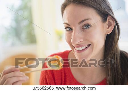 Portrait of woman eating sushi View Large Photo Image Stock Photography - Portrait of woman eating sushi. Fotosearch