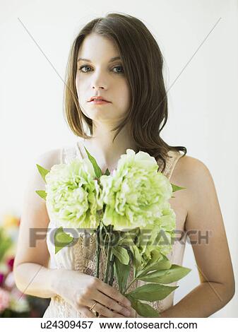 Stock Photo - Portrait of woman holding flowers. Fotosearch