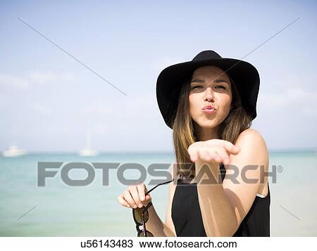 Stock Image - Portrait of woman on beach. Fotosearch