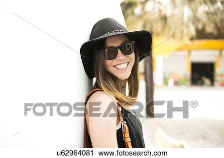 Portrait of woman wearing hat and sunglasses View Large Photo Image Stock Image - Portrait of woman wearing hat and sunglasses. Fotosearch