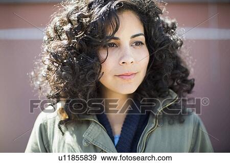 Portrait of woman with dark curly hair View Large Photo Image Stock Photo - Portrait of woman with dark curly hair. Fotosearch