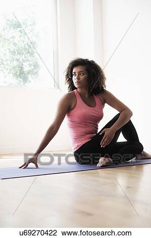 Stock Image - Portrait of young woman at gym. Fotosearch