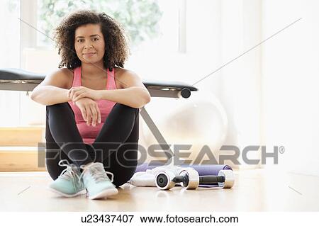 Stock Photo - Portrait of young woman at gym. Fotosearch