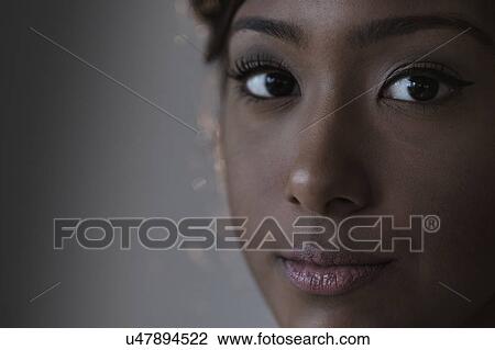 Portrait of young woman in studio View Large Photo Image Stock Image - Portrait of young woman in studio. Fotosearch