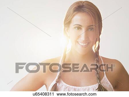 Portrait of young woman in studio View Large Photo Image Stock Image - Portrait of young woman in studio. Fotosearch