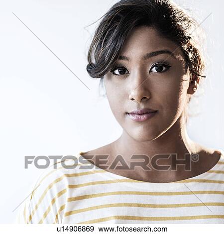 Stock Photo - Portrait of young woman in studio. Fotosearch