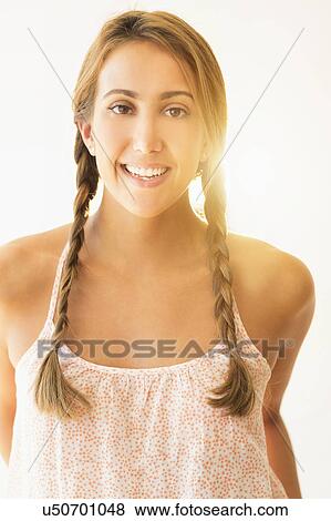 Stock Photo - Portrait of young woman in studio. Fotosearch