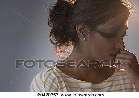 Stock Photo - Portrait of young woman in studio. Fotosearch
