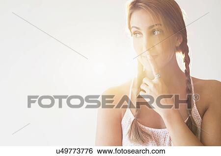 Stock Photograph - Portrait of young woman in studio. Fotosearch