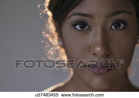 Stock Photography - Portrait of young woman in studio. Fotosearch