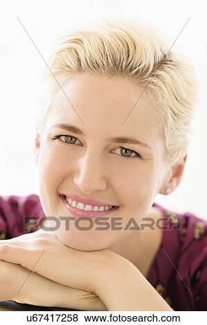 Stock Photo - Portrait of young woman indoors. Fotosearch