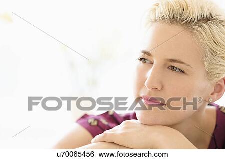 Stock Photograph - Portrait of young woman indoors. Fotosearch