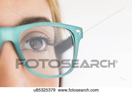 Portrait of young woman wearing eyeglasses in studio View Large Photo Image Stock Photo - Portrait of young woman wearing eyeglasses in studio. Fotosearch