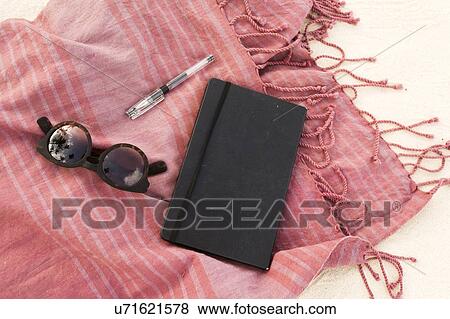 Scarf, notebook, pen and sunglasses on sand View Large Photo Image Stock Photo - Scarf, notebook, pen and sunglasses on sand. Fotosearch