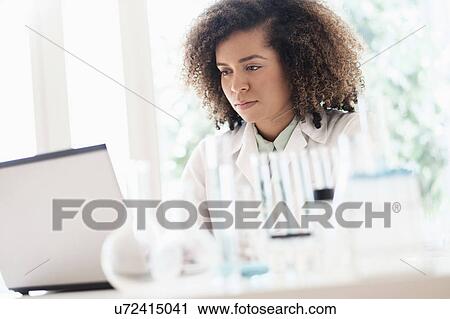 Scientist working on laptop View Large Photo Image Stock Image - Scientist working on laptop. Fotosearch