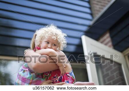 Smiley daughter (4-5) hugging mother View Large Photo Image Stock Image - Smiley daughter (4-5) hugging mother. Fotosearch