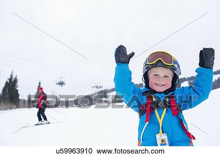 Smiley little boy (5) wearing ski suit in mountains View Large Photo Image Stock Image - Smiley little boy (5) wearing ski suit in mountains. Fotosearch