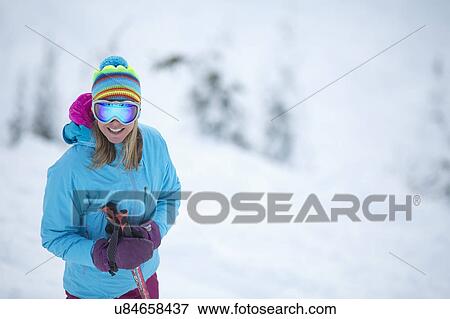 Smiley woman wearing skiwear on ski slope View Large Photo Image Stock Photo - Smiley woman wearing skiwear on ski slope. Fotosearch