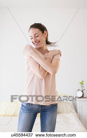 Smiling woman in bedroom View Large Photo Image Stock Photo - Smiling woman in bedroom. Fotosearch