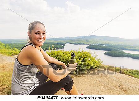 Smiling young female hiker resting View Large Photo Image Stock Image - Smiling young female hiker resting . Fotosearch