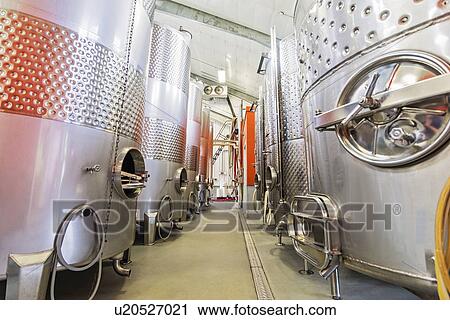 Stock Image - Stainless steel tanks in winery cellar. Fotosearch