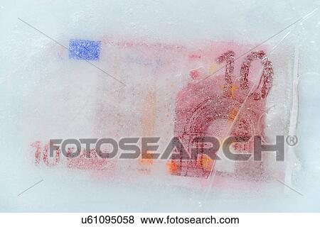 Stock Photo - Studio Shot of 10 euro bill frozen in ice. Fotosearch