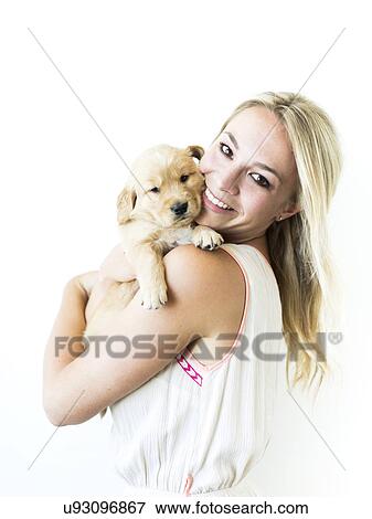 Studio shot of Golden Retriever puppy with owner View Large Photo Image Stock Photo - Studio shot of Golden Retriever puppy with owner. Fotosearch