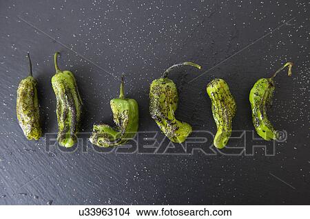Picture - Studio shot of grilled shishito peppers. Fotosearch