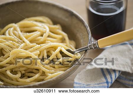 Stock Image - Studio shot of spaghetti alla cacio e pepe. Fotosearch