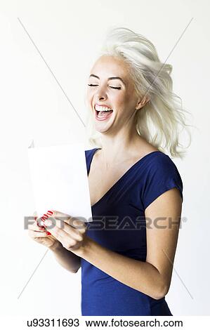Stock Image - Studio shot of woman holding paper. Fotosearch