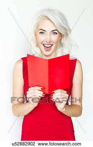 Stock Image - Studio shot of woman wearing red dress. Fotosearch