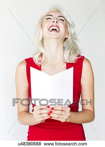 Stock Photo - Studio shot of woman wearing red dress. Fotosearch