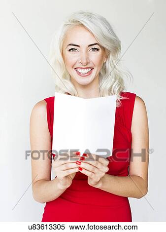 Stock Photography - Studio shot of woman wearing red dress. Fotosearch