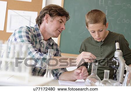 Teacher talking with student (8-9) in classroom View Large Photo Image Stock Image - Teacher talking with student (8-9) in classroom. Fotosearch