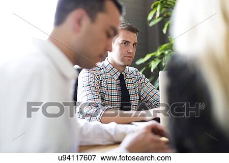 Three office workers during meeting View Large Photo Image Stock Photo - Three office workers during meeting. Fotosearch