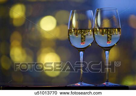 Two wineglasses with white wine View Large Photo Image Stock Image - Two wineglasses with white wine. Fotosearch