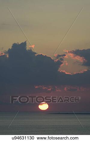 Stock Image - View of sunset sea. Fotosearch
