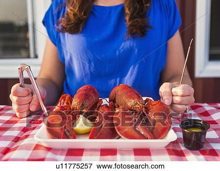 View of table with lobster meal and woman preparing to eat View Large Photo Image Stock Photo - View of table with lobster meal and woman preparing to eat. Fotosearch
