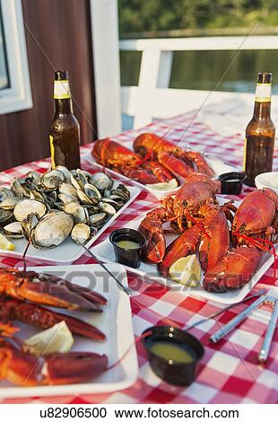 Stock Image - View of table with lobster meal. Fotosearch