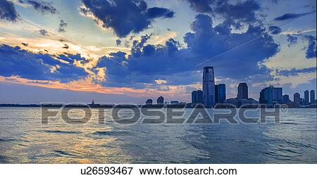 Waterfront cityscape at sunset View Large Photo Image Stock Photo - Waterfront cityscape at sunset. Fotosearch