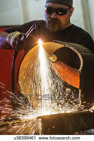 Welder working in metal workshop View Large Photo Image Stock Image - Welder working in metal workshop. Fotosearch