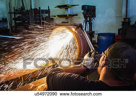 Welder working in metal workshop View Large Photo Image Stock Image - Welder working in metal workshop. Fotosearch