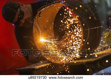 Welder working in metal workshop View Large Photo Image Stock Image - Welder working in metal workshop. Fotosearch