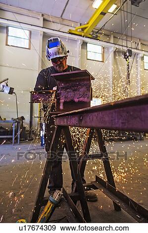 Stock Photo - Welder working in metal workshop. Fotosearch