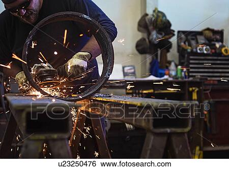 Stock Photograph - Welder working in metal workshop. Fotosearch