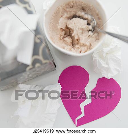 Stock Photo - Wet facial tissues and ice cream on table. Fotosearch