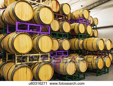 Stock Image - Wine barrels on racks in cellar. Fotosearch